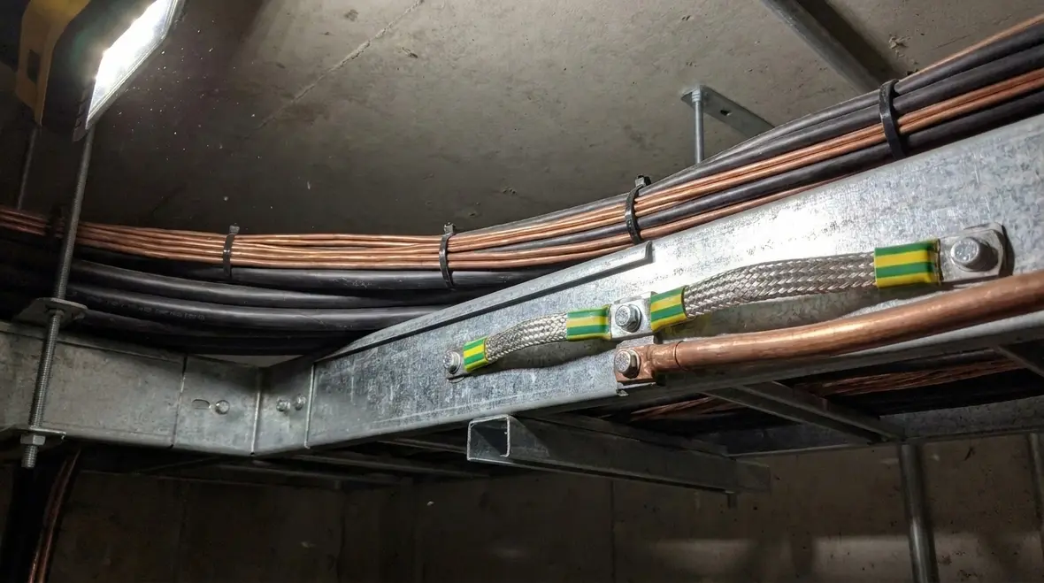 Bonding and grounding conductors arranged for NEC-compliant surge arrester performance