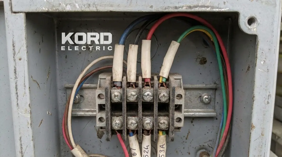 Electrical technician using labeled terminals for safe troubleshooting
