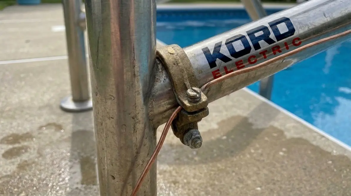 Technician inspecting bonded pool equipment in a commercial facility