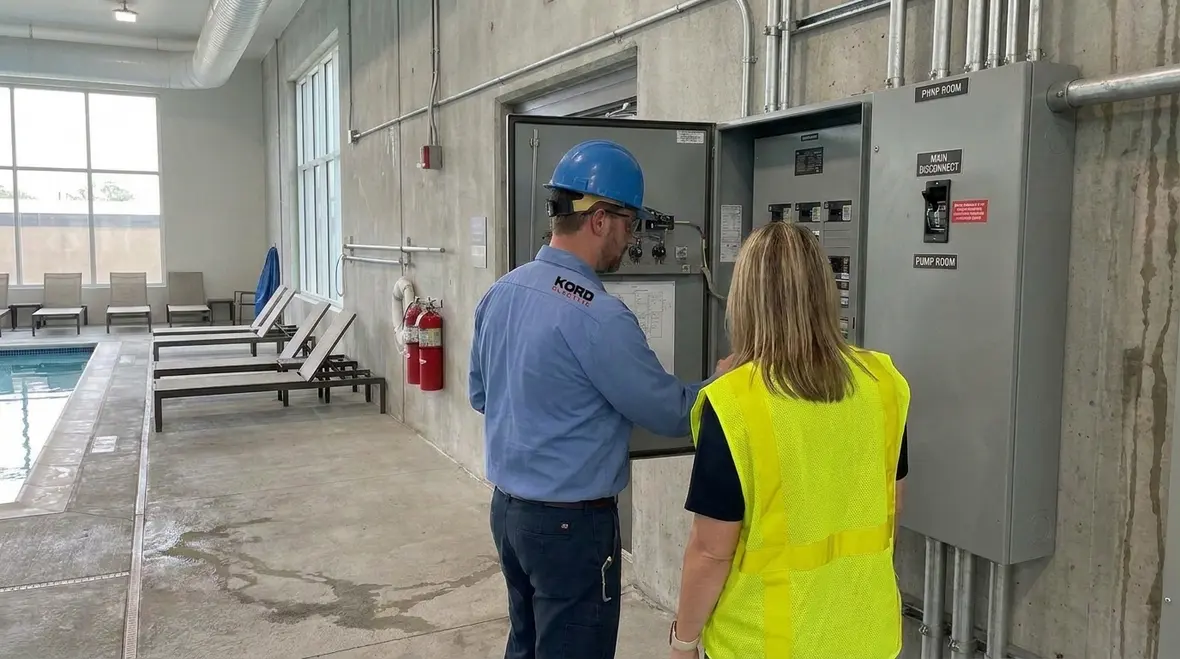 Commercial pool electrical room with labeled panels, bonding bars, and protection devices