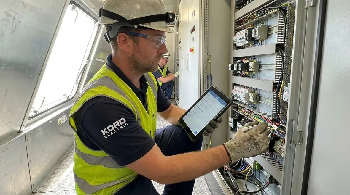 Inspector reviewing NEC-compliant wind generator installation and documentation