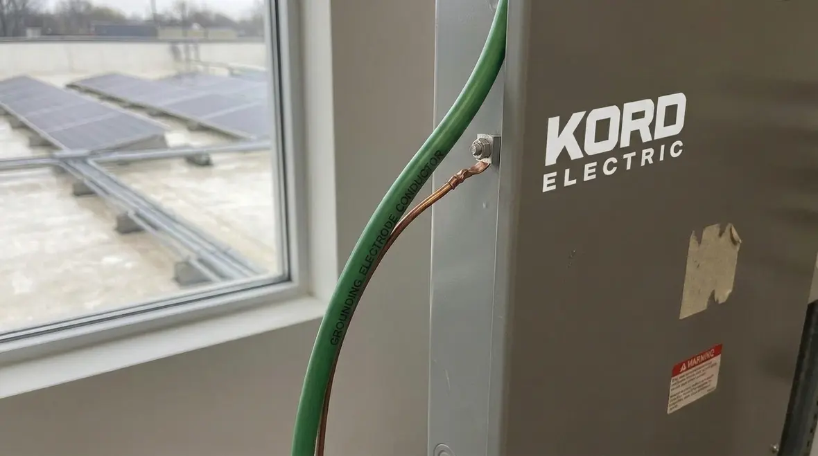 Technician inspecting PV station bonding and grounding continuity