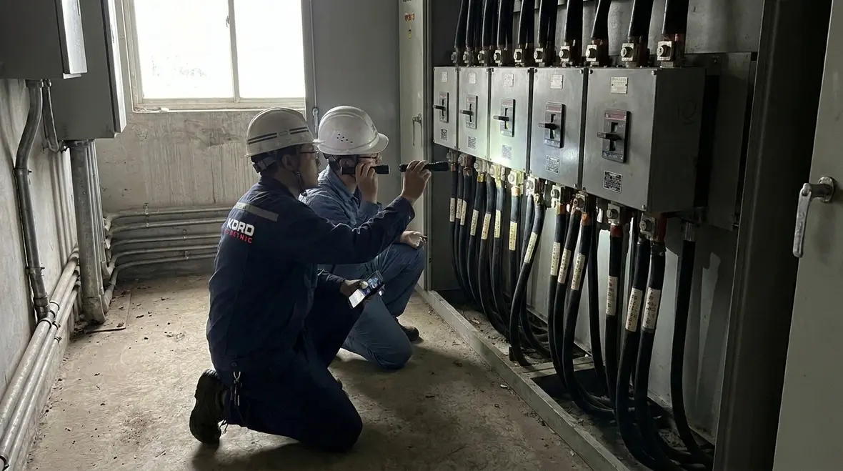 Technicians reviewing NFPA 70 Section 694.12 wind turbine circuit sizing diagrams